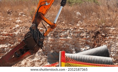 Excavator and Pipes. Hot Sunny Weather. Gound on the Background