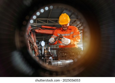 An Excavator Repair Technician Use Vernier Caliper And Holding Bulldozer Sprocket To Inspection And Repair Maintenance Heavy Machinery, Industrial Theme.