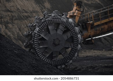 Excavator rotor on the background of coal in the coal face