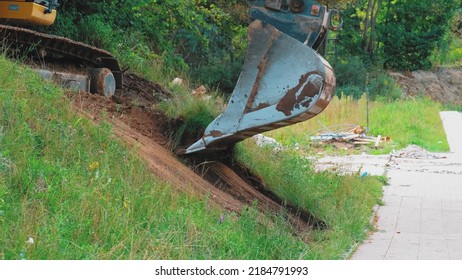 Excavator Scoop Bucket Leveling Ground On Grass Slope