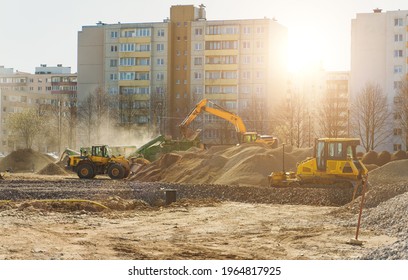 Excavator and screener machine working on construction site.