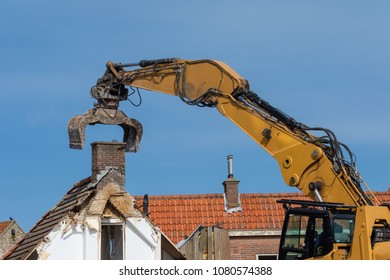 Excavator Tear Down An Old House For New Buildings