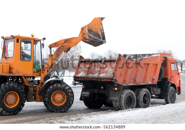 excavator and truck, clean the snow from roads and\
sidewalks in winter