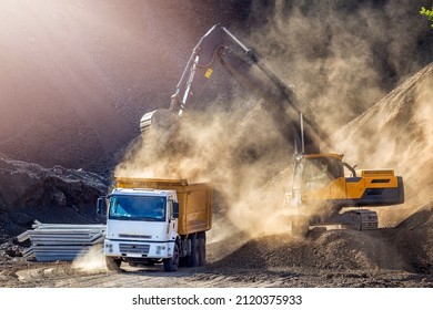 Excavator and truck for construction site. Excavation is the process of moving earth, rock or other materials with tools, equipment or explosives. It includes earthwork, trenching, wall and tunneling. - Shutterstock ID 2120375933