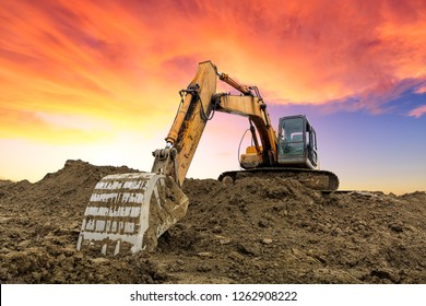 Excavator Work On Construction Site At Sunset