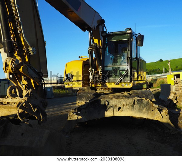 Excavator in working environment, construction,\
construction car, car with hydraulics, yellow excavator,\
construction industry,\
clay