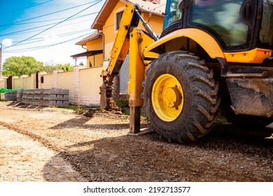 The Excavator Works On The Street Before Laying Paving Stones