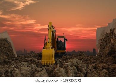Excavators are digging the soil in the construction site on the  sunset  sky background