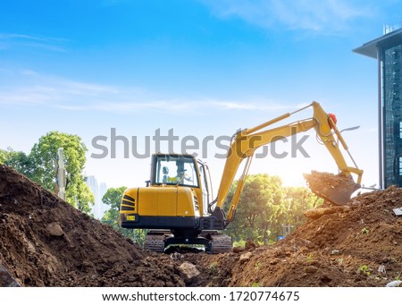 Excavators excavate earth at the construction site
