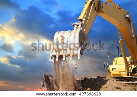 Excavators machine in construction site on sunset background