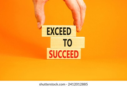 Exceed to succeed symbol. Concept words Exceed to succeed on beautiful wooden blocks. Beautiful orange table orange background. Businessman hand. Business and exceed to succeed concept. Copy space.