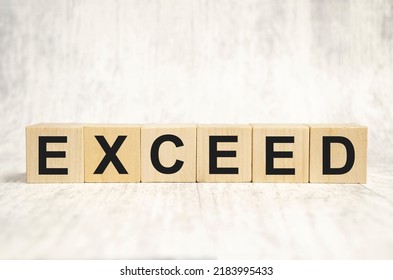 Exceed Word On Wooden Blocks And White Background