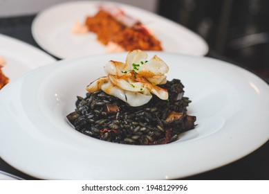 An Excellent Gourmet Dish Of Seafood Paella Style Squid Ink Black Rice In A Fancy Restaurant