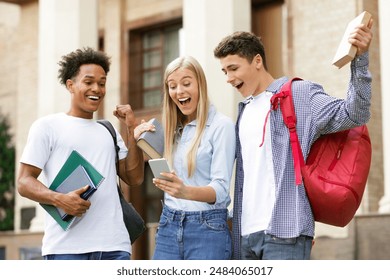 Excellent marks. Surprised students checking exam results online on smartphone