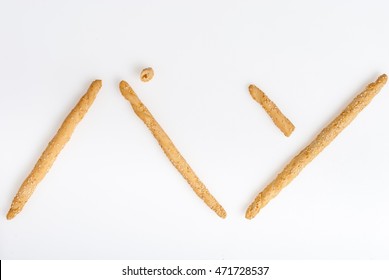 Excellent and natural breadsticks with sesame seeds with them clearly visible on the surface, Arranged so that they form the Japanese Kanji ideogram for bread and isolated on white background