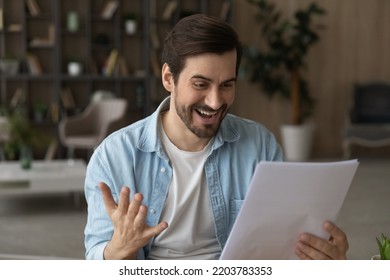 Excellent News. Overjoyed Young Man College University Student Hold Official Letter With Good Test Exam Supervised Task Result High Grade. Successful Millennial Male Freelancer Get New Great Job Offer