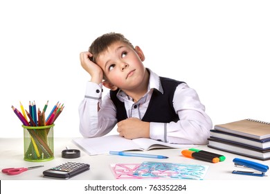 Excellent Pupil Thinking Over The Puzzle Sitting At The Studing Desk With White Background