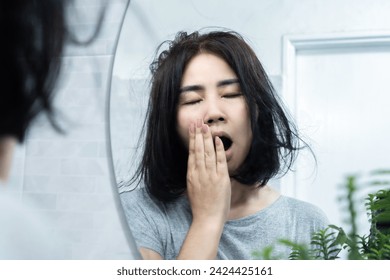 excessive yawning concept with fatigued Asian woman feeling tired and yawn all the time, medical condition, sleep disorder 