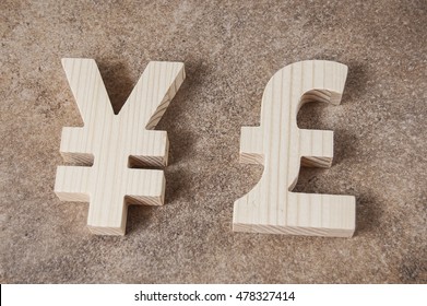 Exchange currency YUAN with POUND unit on a stone background - Powered by Shutterstock