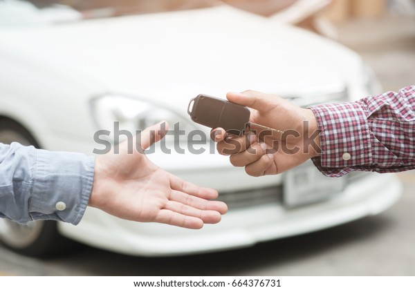 exchange handing over the car keys for to a\
young businessman.