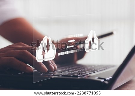 Exchange information data with internet cloud technology. Business person hand using laptop computer and smartphone with virtual popup icon of cloud computing Storage and data transfer Cloud network.