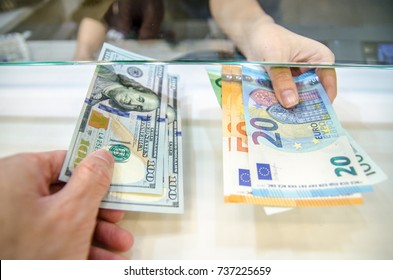 Exchange money, Exchange US dollar or American dollars (USD) for EUR money, A man and women are exchanging dollars for euros. - Shutterstock ID 737225659