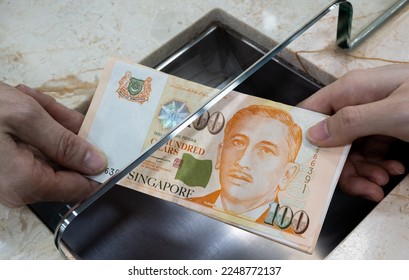 exchanging money at cash department window. Singapore dollar - Shutterstock ID 2248772137
