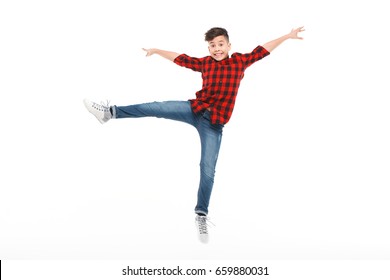 Excite kid in casual clothing posing with leg up and hands apart isolated on white.  - Shutterstock ID 659880031