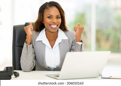 Excited African American Businesswoman Waving Fists In Office