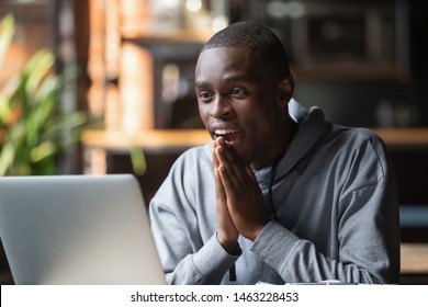 Excited African American Guy Look At Laptop Screen Feel Surprise Get Great News From College, Overjoyed Amazed Black Male Student Reading Email Receive College Admission Or Job Promotion Letter