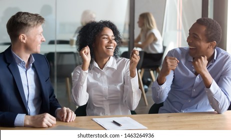 Excited African American Husband And Wife Feel Euphoric Buy House Together Signing Contract Closing Deal With Realtor, Happy Overjoyed Black Couple Sit At Banker Office Take Property Loan Or Mortgage