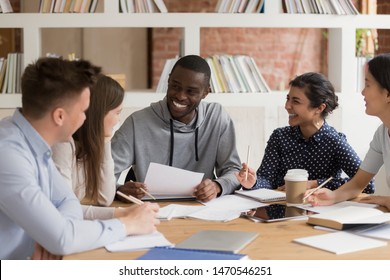 Excited African American Male Student Having Fun With Mixed Race Friends While Preparing For Session. Group Of Diverse Students Sitting In Classroom, Joking, Laughing, Enjoying Study Time Together.