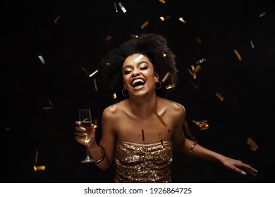 Excited African American Woman In Party Dress Drinking Champagne Isolated Over Black Background