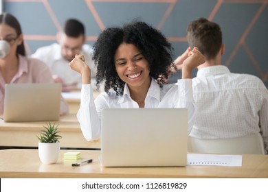 Excited African American worker screaming with happiness winning online lottery, happy black employee getting promotion letter at laptop, relocating to dream position. Rewarding concept - Shutterstock ID 1126819829