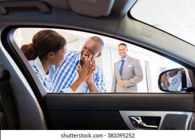 Excited African Couple At The Dealership Buying New Car