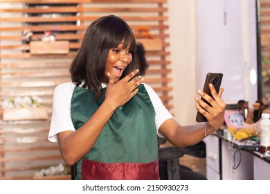 Excited African Makeup Artist Checking Her Phone