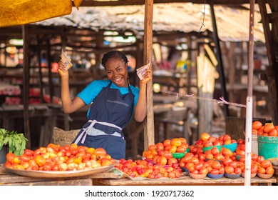 Excited African Market Woman Feeling Excited And Happy Holding Some Money