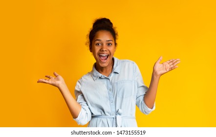 Excited African Teen Girl Screaming Over Yellow Background, Looking At Camera. Panorama with copy space