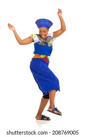 Excited African Woman In Traditional Clothes Dancing