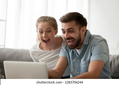 Excited Amazed Couple Looking At Laptop Happy Surprised By Online Betting Winning Bid, Good Internet News, Unbelievable Email Sale Offer Celebrate Victory Achievement, Feeling Winners, Watching Game