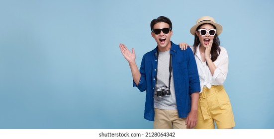 Excited Asian Couple Tourist Dressed In Summer Clothes To Travel On Holidays Isolated On Blue Copy Space Background.