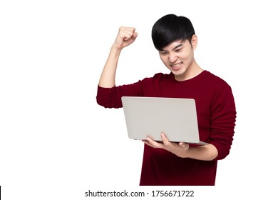 Excited Asian Man Looking At Laptop Computer Screen And Raising His Arm Up With Celebrating Success Isolated Over White Background