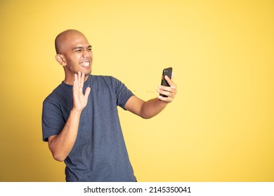 Excited Asian Man Waving Hand When Make Video Call