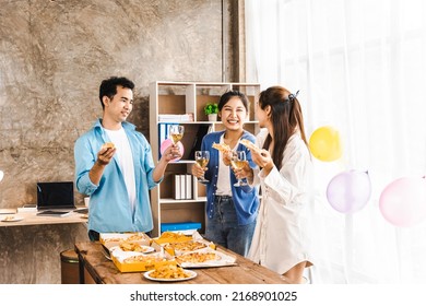 Excited Asian men and women laugh at jokes. Eat pizza with various colleagues in the office. Multi-ethnic staff having fun together during lunch enjoy a good conversation mood - Powered by Shutterstock