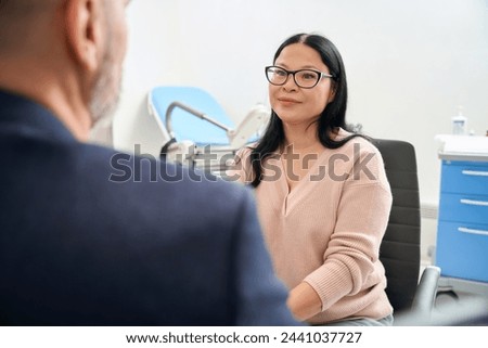 Excited asian woman waiting for husband reaction on her long-awaited pregnancy