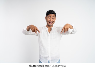 Excited Asian Young Man With Two Fingers Pointing Down