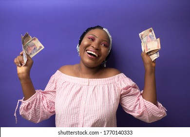 Excited Beautiful African Lady Holding Nigerian Currency With Her Two Hands