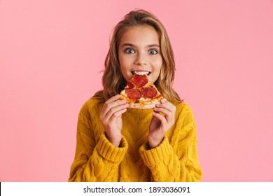 Excited beautiful blonde girl eating pizza at camera isolated over pink background