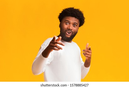 Excited Black Guy Indicating At Camera, Happy To See Someone, Orange Studio Background