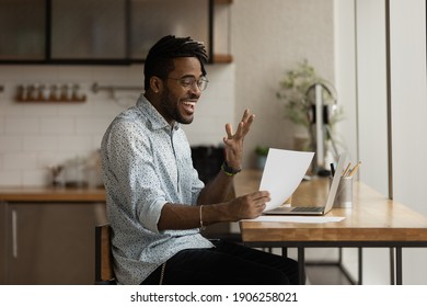 Excited Black Guy Student Express Delight Read Official Letter About Admission To College. Happy Young African Man Freelancer Amazed With New Great Opportunities For Business Written In Paper Document